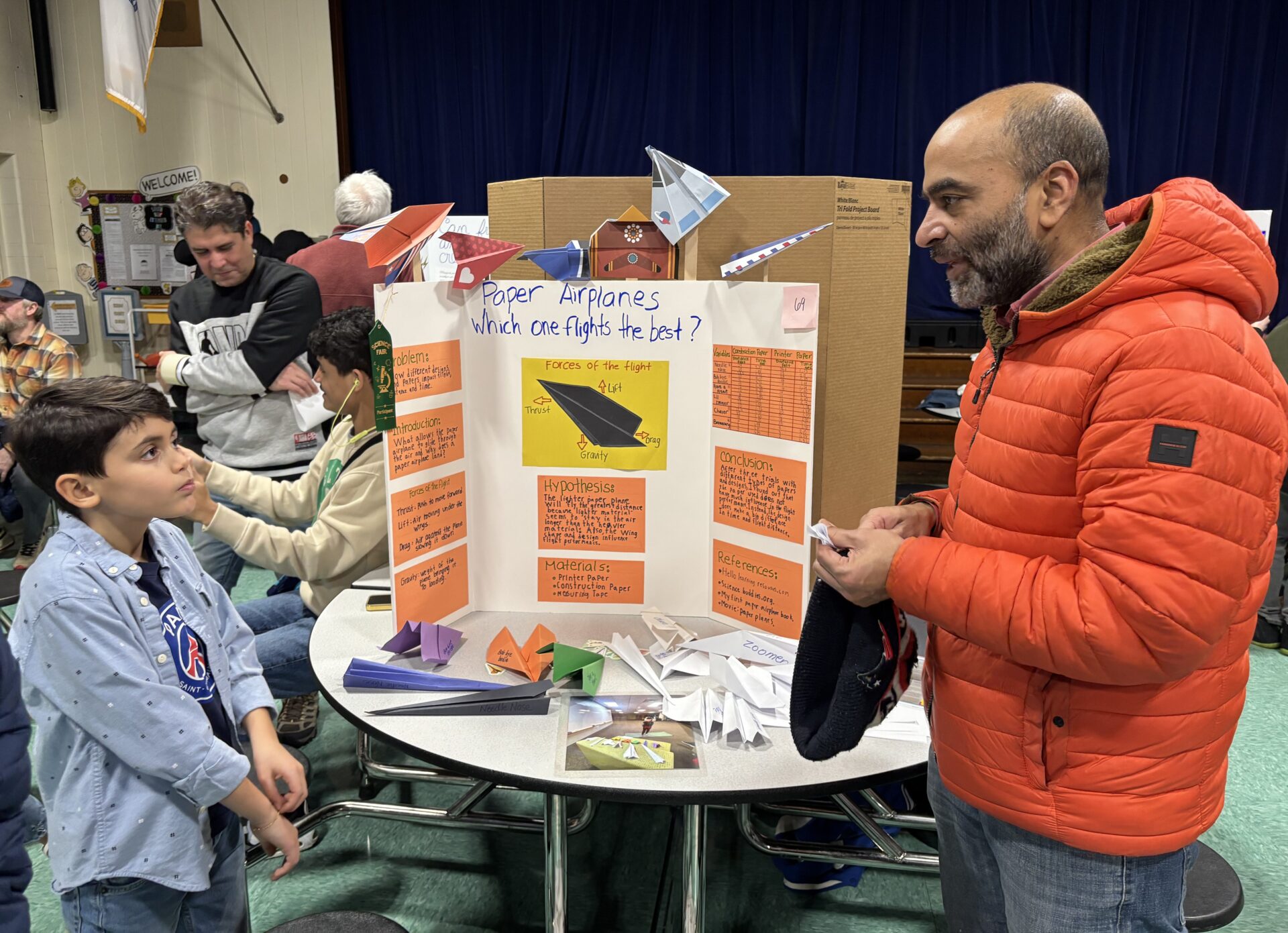 IMG_3186 South Row Elementary School fourth grader Matias Paternina fields questions about his science project which explores how far paper airplanes can fly.